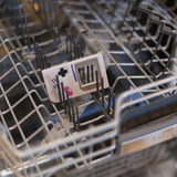 Bumkins Silicone Teether: Game Boy™ sits in the top rack of an open dishwasher.