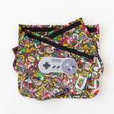 Bumkins Silicone Teether: Nintendo SNES™ Controller sits on top of colorful waterproof pouches on a white background.