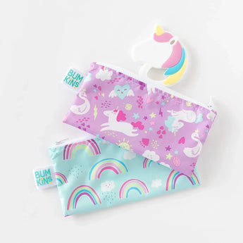 Two colorful purple and blue pouches sit on a white background with a Bumkins Silicone Teether: Unicorn.