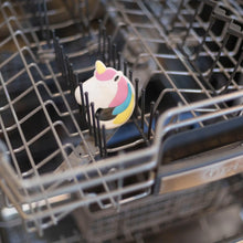 Load image into Gallery viewer, Bumkins Silicone Teether: Unicorn sits in the top rack of an open dishwasher.