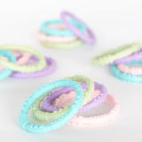 Multiple sets of Bumkins Silicone Teething Rings 4 Pack: Spring are arranged on a white background.