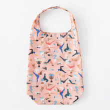 Load image into Gallery viewer, Bumkins Packable Tote Bag: Yoga Pals folds itself into its pocket on a white background in a stop motion GIF.