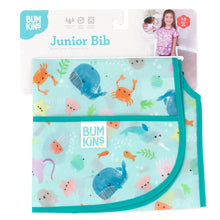 Load image into Gallery viewer, Bumkins Junior Bib: Ocean Life is shown folded on white cardboard packaging.
