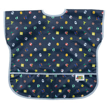 Load image into Gallery viewer, Bumkins Junior Bib: Super Mario™ Lineup features dark waterproof fabric with colorful icons like mushrooms, stars, and coins.
