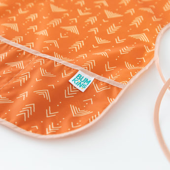 Close-up of Bumkins Short-Sleeved Smock: Grounded on a white background, with focus on the pocket.