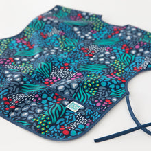 Load image into Gallery viewer, Close-up of Bumkins Short-Sleeved Smock: Animal Prints on a white background, with focus on the bottom pocket.