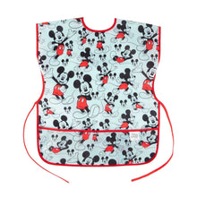 Load image into Gallery viewer, Bumkins Short-Sleeved Smock: Mickey Mouse Classic features a Mickey Mouse design on blue waterproof fabric, red trim, and adjustable closures.