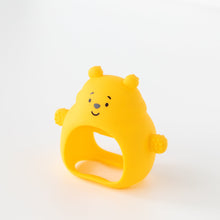 Load image into Gallery viewer, Bumkins Silicone Un-Droppable Mitt Teether: Winnie the Pooh stands angled on a white background.
