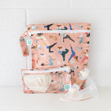 Load image into Gallery viewer, Bumkins Wet Bag: Yoga Pals sits on a white table against a white brick wall, with breast pump parts and a matching bag in front.