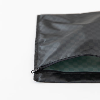 Roamio by Bumkins Wet Bag: Rich Black lays partially open on a white background, revealing the interior.