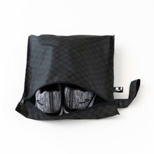 Load image into Gallery viewer, Roamio by Bumkins Wet Bag: Rich Black holds gray sneakers on a white background.
