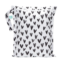 Load image into Gallery viewer, Bumkins Wet Bag: Hearts features a black heart pattern on white waterproof fabric, a zipper closure, and side handle.