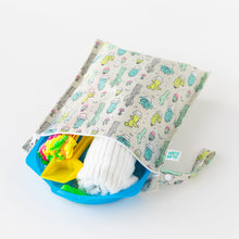 Load image into Gallery viewer, Bumkins Wet Bag: Cacti lays open on a white background with a white towel and colorful pool toys peeking out.