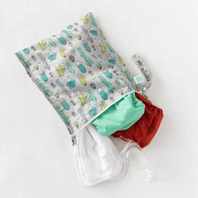 Load image into Gallery viewer, Bumkins Wet Bag: Cacti holds cloth diapers, white cloths, and breast pump parts on a white background.