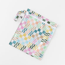 Load image into Gallery viewer, Roamio by Bumkins Wet Bag: Motley Check lays flat on a white background.