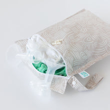 Load image into Gallery viewer, Breastfeeding essentials peek out of an open Bumkins Wet Bag: Wander laying on a white background.