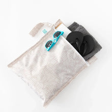 Load image into Gallery viewer, Bumkins Wet Bag: Wander holds a book, teal sunglasses, black flip-flops, and a folded gray towel on a white background.