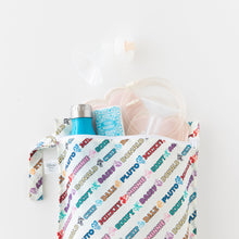 Load image into Gallery viewer, Bumkins Wet Bag: Mickey & Friends Varsity is shown on a white background holding breast pump parts, a blue bottle, tissues, and breast pads.