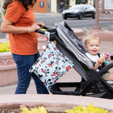 Load image into Gallery viewer, A person in jeans pushing a stroller outside with a Bumkins Wet Bag: Mickey & Friends Forever attached to the handle.