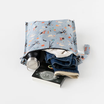 Bumkins Wet Bag: No Tricks, Just Treats showcases a bottle, clothes, and book against a crisp white backdrop.