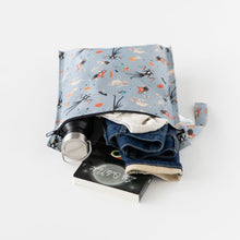 Load image into Gallery viewer, Bumkins Wet Bag: No Tricks, Just Treats showcases a bottle, clothes, and book against a crisp white backdrop.