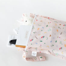 Load image into Gallery viewer, Bumkins Wet Bag: Princess Magic holds a notebook, soft toy, and brush on a white background.