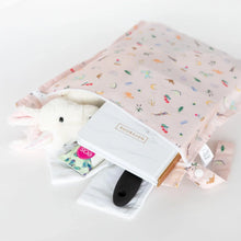 Load image into Gallery viewer, Bumkins Wet Bag: Princess Magic holds a stuffed toy, notebook, and brush on a white background.