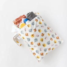 Load image into Gallery viewer, Bumkins Wet Bag: Winnie and Friends, filled with toiletries, a small towel, and swim trunks, rests on a white background.