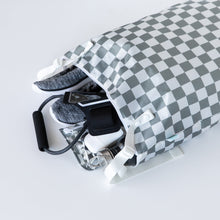 Load image into Gallery viewer, Bumkins Extra Large Wet Bag: Charcoal Check opens to reveal sneakers, phone, and gym gear spilling onto a white background.