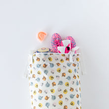 Load image into Gallery viewer, Bumkins Extra Large Wet Bag: Winnie + Friends holds a ball and pink sneakers; an orange mouthguard is nearby on a white background.