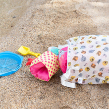 Load image into Gallery viewer, Beach toys lay scattered near a Bumkins Extra Large Wet Bag: Winnie + Friends lying on the sand.