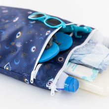 Load image into Gallery viewer, Close-up of Bumkins Wet/Dry Bag: Evil Eye, holding sunglasses, shoes, sunscreen, diapers, and toys on a white background.