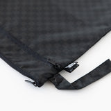 Close-up of Roamio by Bumkins Wet/Dry Bag: Rich Black, featuring zippered compartments and a side handle, on a white background.
