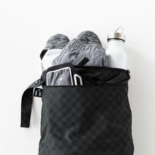 Load image into Gallery viewer, Roamio by Bumkins Wet/Dry Bag: Rich Black holds shoes, clothes, and a water bottle on a white background.