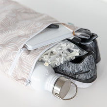 Load image into Gallery viewer, Bumkins Wet/Dry Bag: Wander fits a water bottle, book, gloves, and golf tees; gray sneakers peek out on a white background.