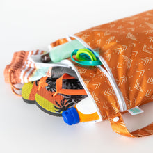 Load image into Gallery viewer, Close-up of Bumkins Wet/Dry Bag: Grounded with flip-flops, shorts, sunscreen, and goggles on a white background.