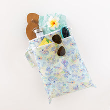Load image into Gallery viewer, Bumkins Wet/Dry Bag: Aloha Stitch, filled with sandals, a flower, sunglasses, a bottle, a brush, and teal shorts, sits on a white background.