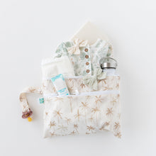 Load image into Gallery viewer, Baby essentials displayed in a Bumkins Wet/Dry Clutch: Palm Daze on a white background: clothes, pacifier, bottle, diaper.