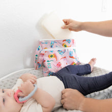 Load image into Gallery viewer, A person reaches for wipes from a Bumkins Wet/Dry Clutch: Boots on a changing table, sitting next to a baby clutching a teething ring.
