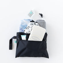 Load image into Gallery viewer, Bumkins Wet/Dry Clutch: Black holds baby essentials—wipes, lotion, diapers, cloth, sanitizer & pacifier—on a white background.