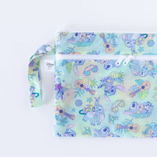 Load image into Gallery viewer, Bumkins Wet/Dry Clutch: Aloha Stitch is half visible as it lays flat on a white background.