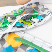 Load image into Gallery viewer, Close-up of Bumkins Clear Travel Bag 3 Pack: Charcoal Check, filled with colorful blocks and toy tools on a white table.