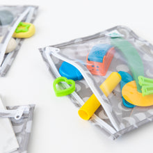 Load image into Gallery viewer, Bumkins Clear Travel Bag 3 Pack: Lunar Phase holds colorful cookie cutters and play dough on a white table.