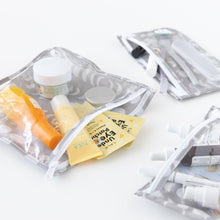 Load image into Gallery viewer, Bumkins Clear Travel Bag 3 Pack: Lunar Phase filled with skincare sachets and toiletries on a white background.