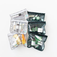 Load image into Gallery viewer, Bumkins Clear Travel Bag 3 Pack: Lunar Phase is filled with skincare items and showcased on a white background next to other similar bags.
