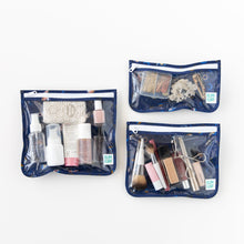 Load image into Gallery viewer, Bumkins Clear Travel Bag 3 Pack: Evil Eye, filled with makeup and toiletries, are set on a white background.