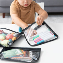 Load image into Gallery viewer, A child organizes markers into Bumkins Clear Travel Bag 3 Pack: Rich Black at a white table.