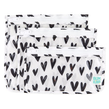 Load image into Gallery viewer, Bumkins Clear Travel Bag 3-Pack: Hearts includes 3 TSA-compliant pouches made of white waterproof fabric with black hearts.