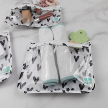 Load image into Gallery viewer, Close-up of rolled cloths and a cactus-shaped teether in a Bumkins Clear Travel Bag 3-Pack: Hearts on a marble background.
