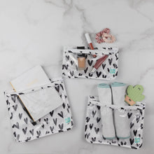 Load image into Gallery viewer, Bumkins Clear Travel Bag 3-Pack: Hearts holds a notebook, makeup, burp cloths, and a teether on a marble background.